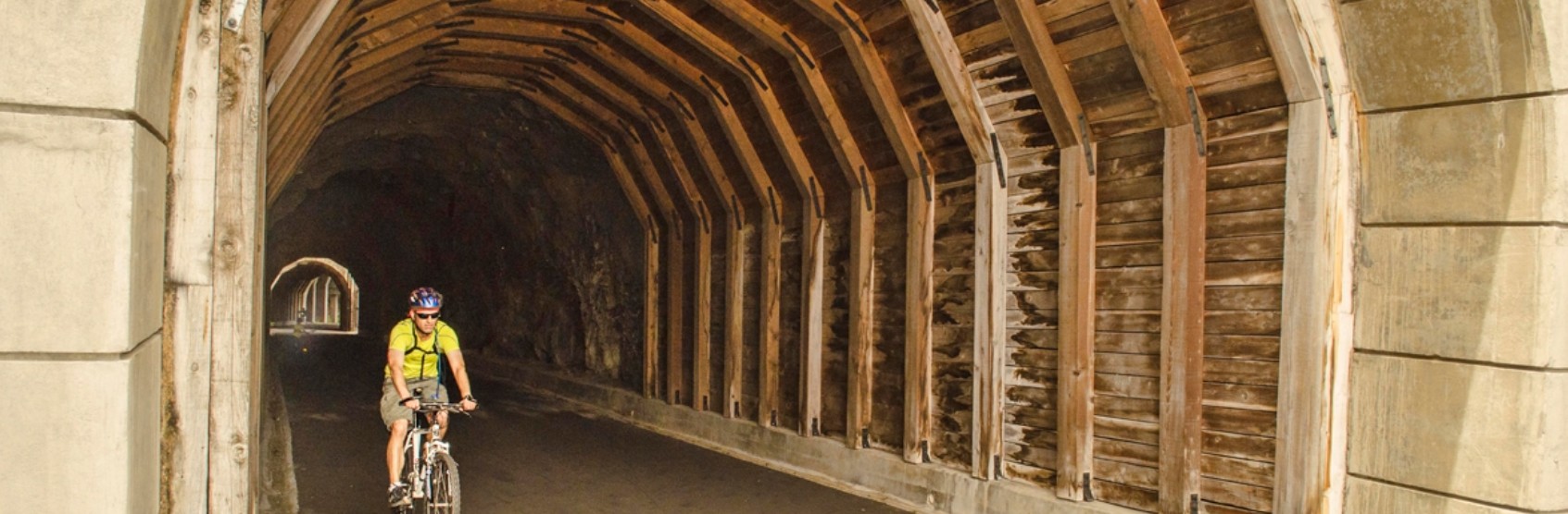 A man biking through the Mosier Twin Tunnels