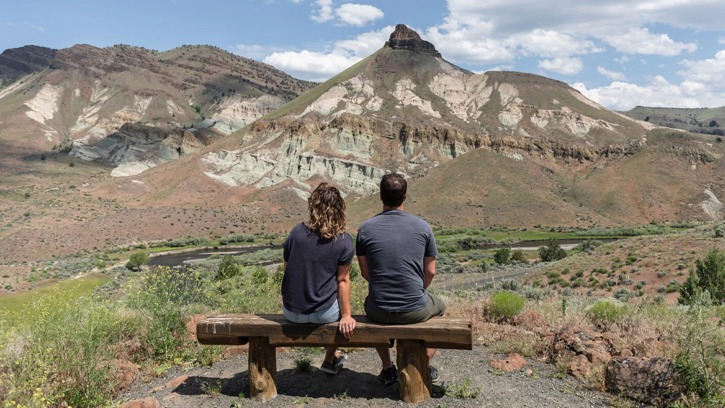 A couple gaze at the majestic view of Sheep Rock