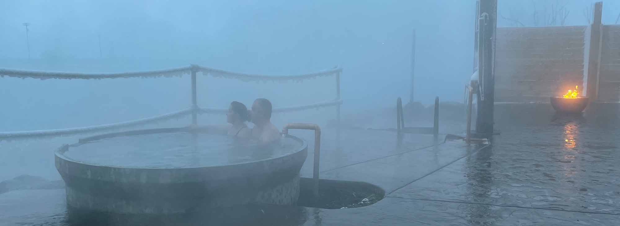 A couple relaxing in the hot springs at Hot Lake