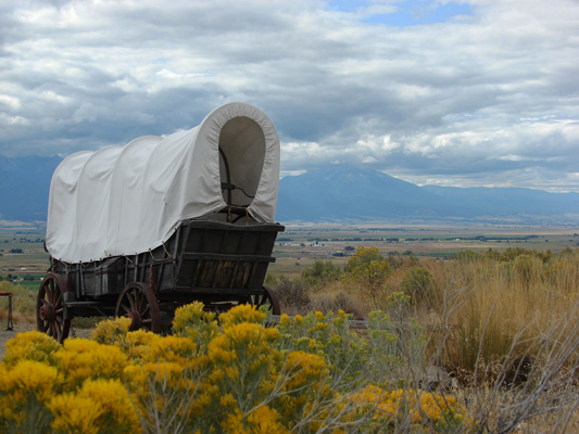 wooden covered wagon in scenic desert setting