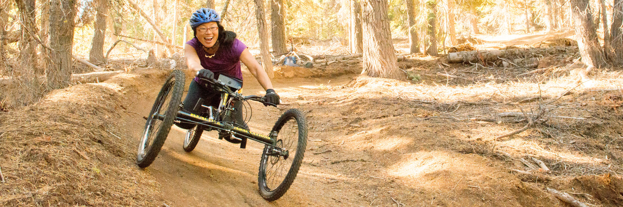 A woman riding an adaptive mountain bike