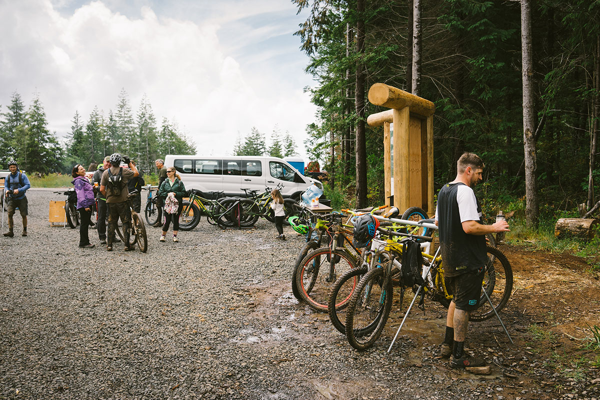 Trailhead and people with bikes at Whiskey Run Trails in Bandon, Oregon
