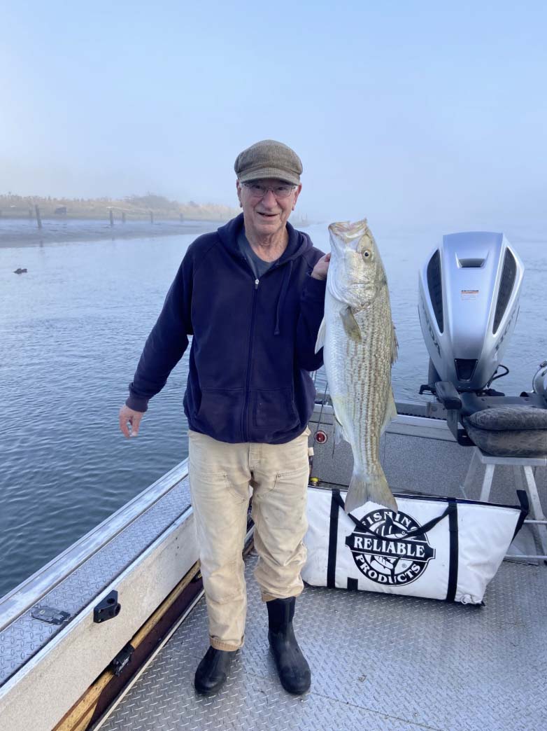 Man holding up a fish he caught with Fish Oregon Guide Service in Bandon, Oregon