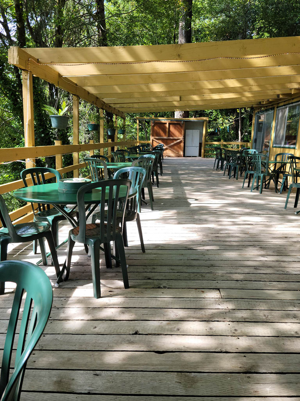 Outdoor deck and dining area at Singing Springs Resort in Agness, Oregon