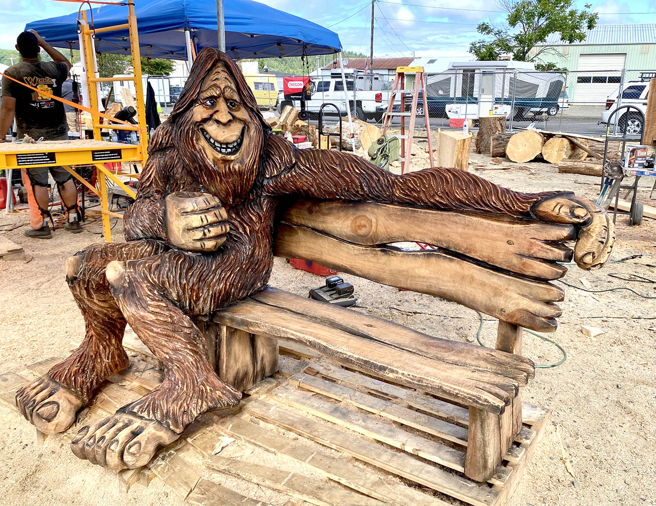 Chainsaw carving of a sasquatch sitting on bench at the Oregon Divisional Chainsaw Carving Championship in Reedsport, Oregon