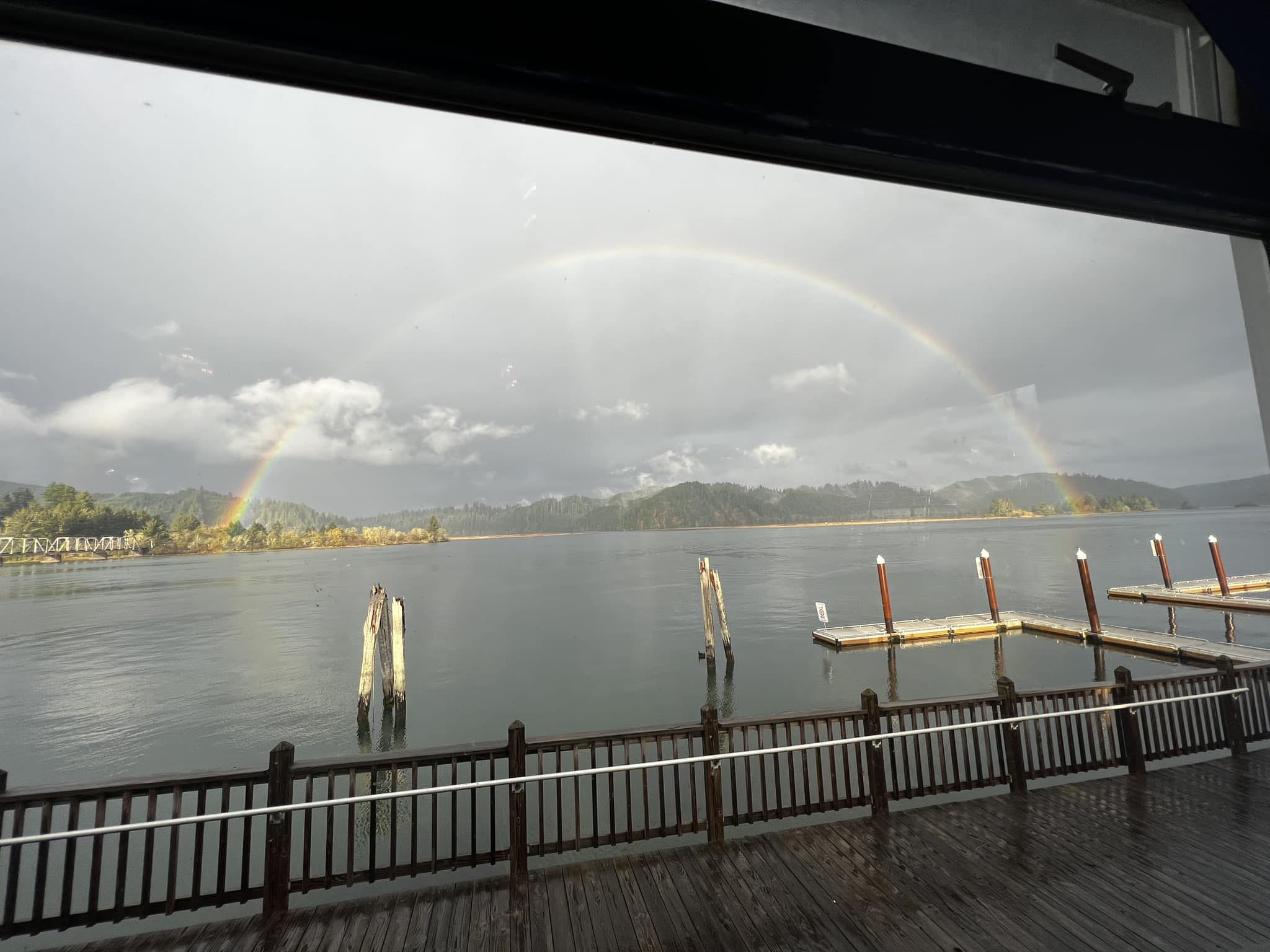 View of Umpqua River and rainbow at Big Fish Cafe in Reedsport, Oregon