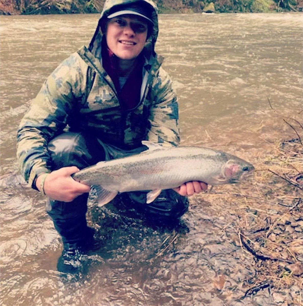 Man with a fish in the river in Oregon