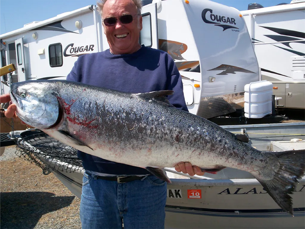 Man holding fish from fishing trip at Oceanside RV Park in Gold Beach, Oregon