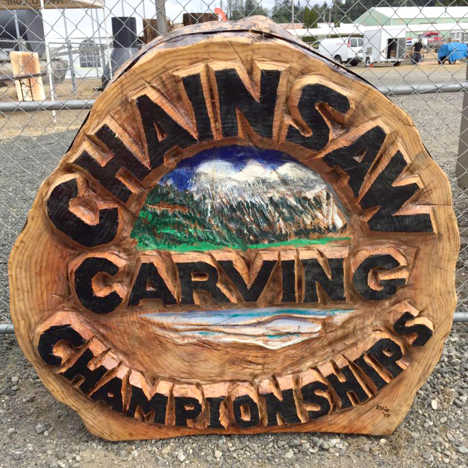 Chainsaw carving of sign for Oregon Divisional Chainsaw Carving Championship in Reedsport, Oregon