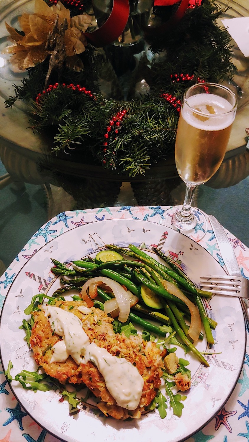 Dinner plate with crab cakes, asparagus, and champagne