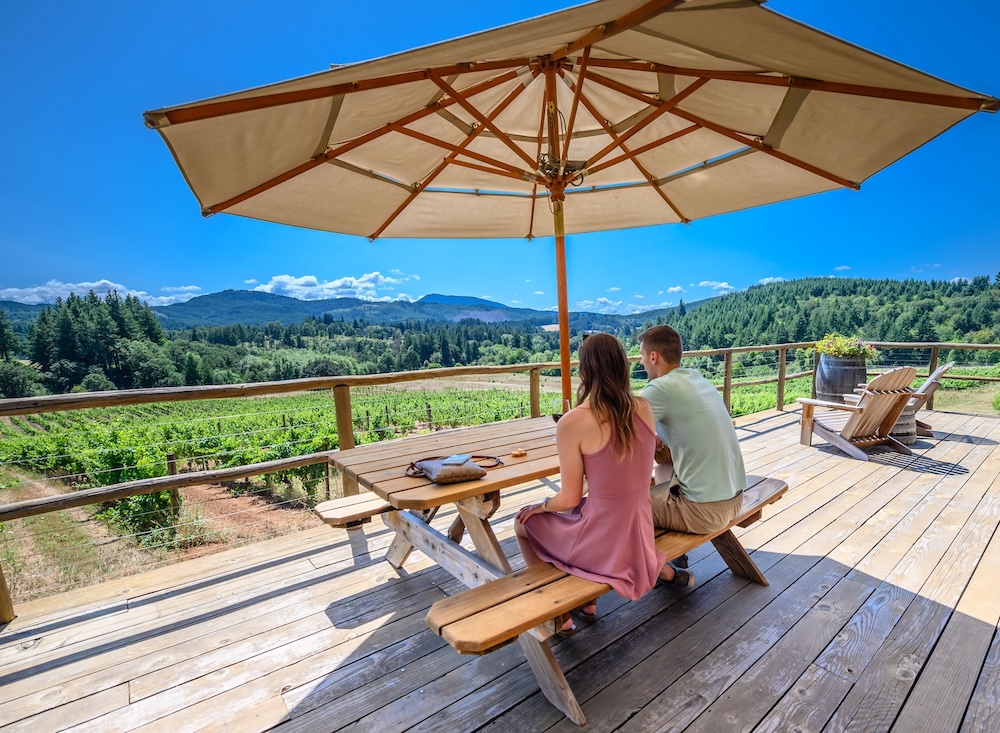 A couple enjoying wine and mountain views at Lumos Wine Co.