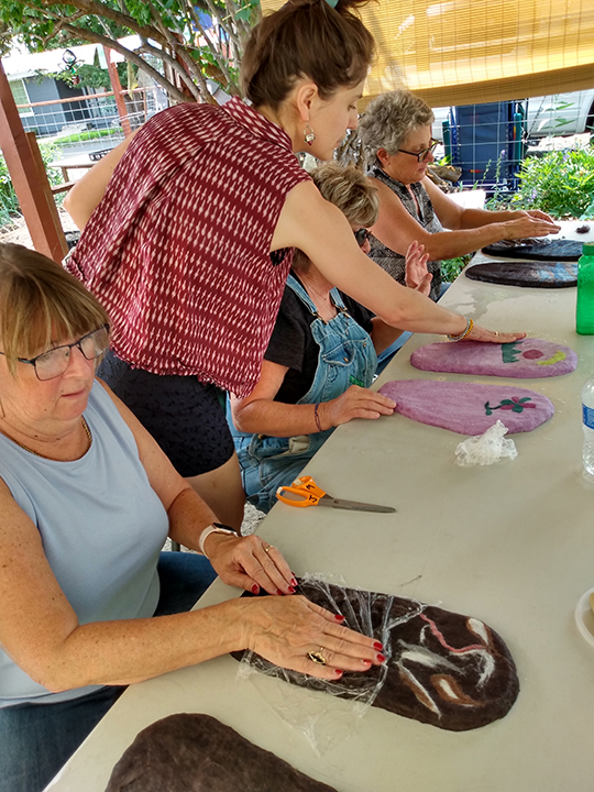 three woman participating in a felted slippers workshop