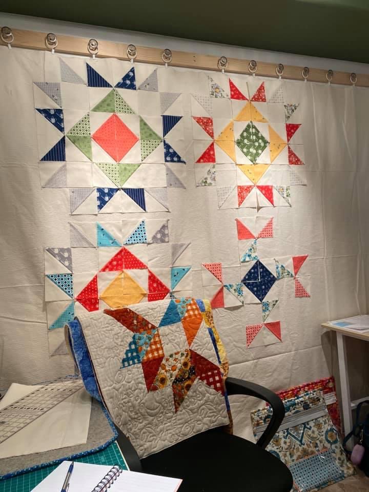 quilt display featuring a variety of colors