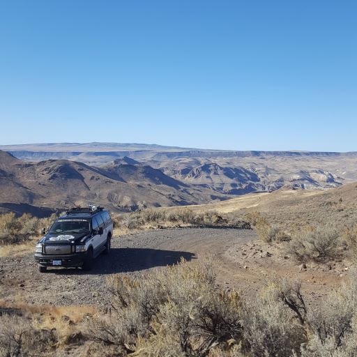 Calamity Butte Guide Service vehicle in an open landscape