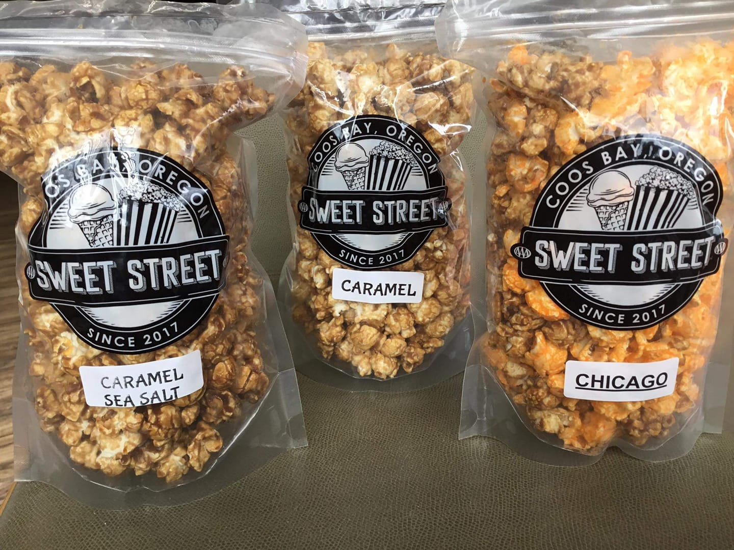 Three bags of flavored popcorn by Sweet Street