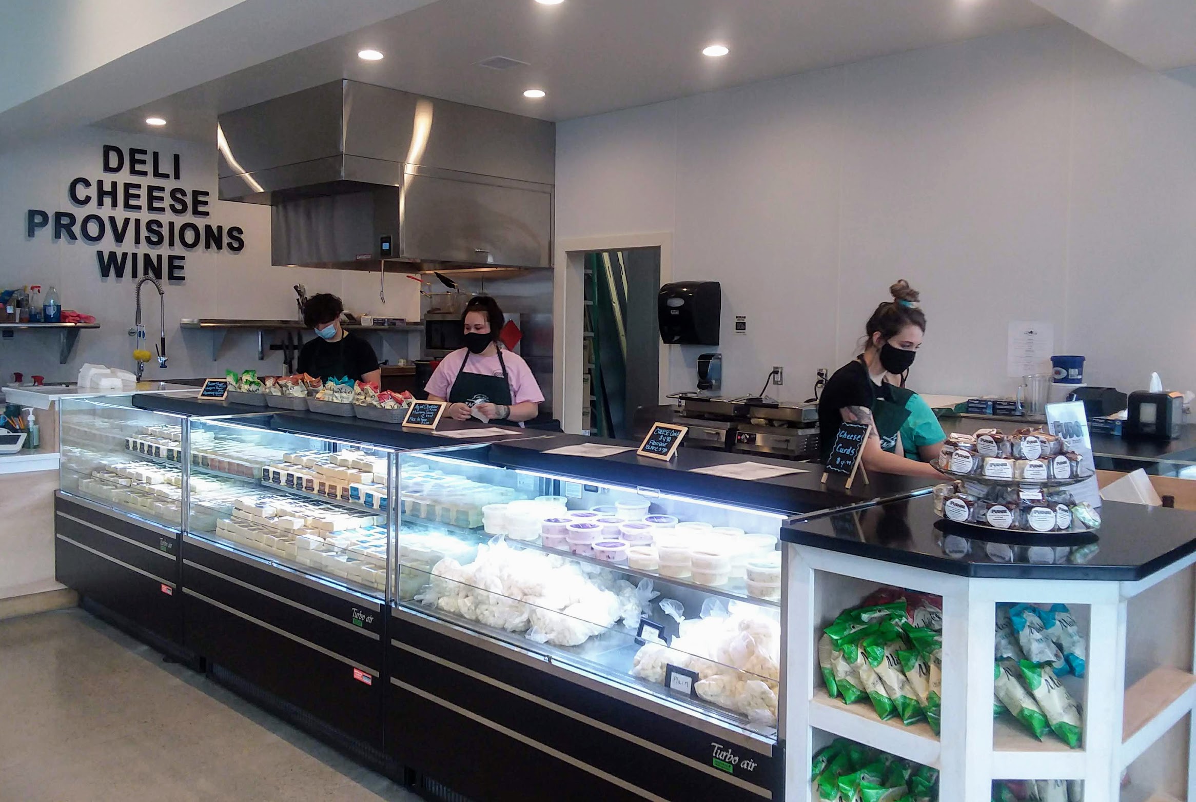 cafe employees working behind display counter