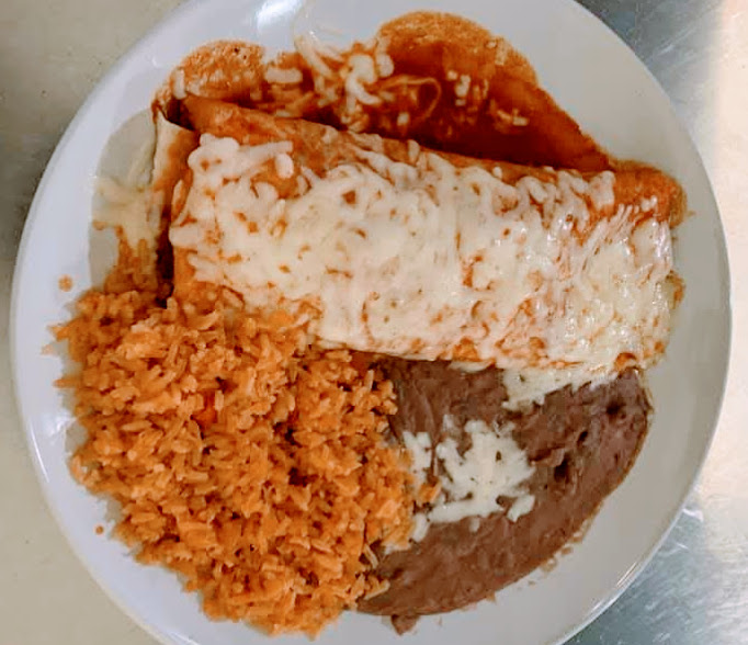 burrito colorado with rice and beans on a white plate