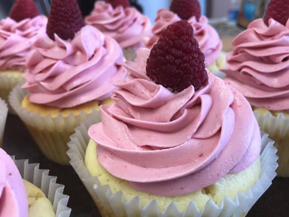 display of lemon cupcakes with swiss buttream frosting and raspberry curd