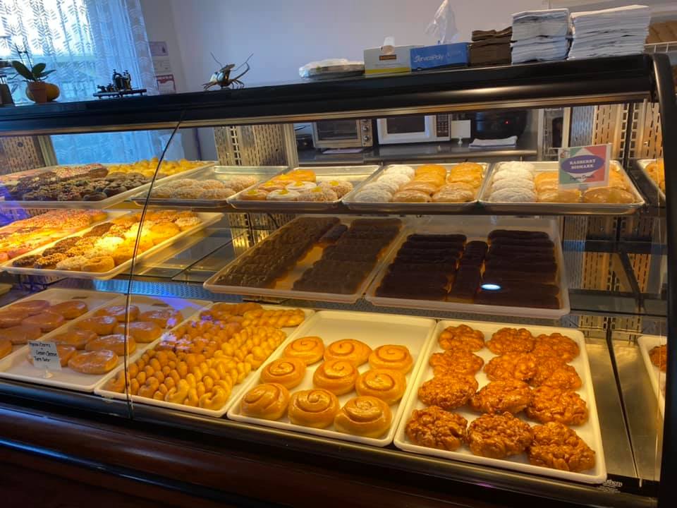 in-store display case showing a variety of donuts