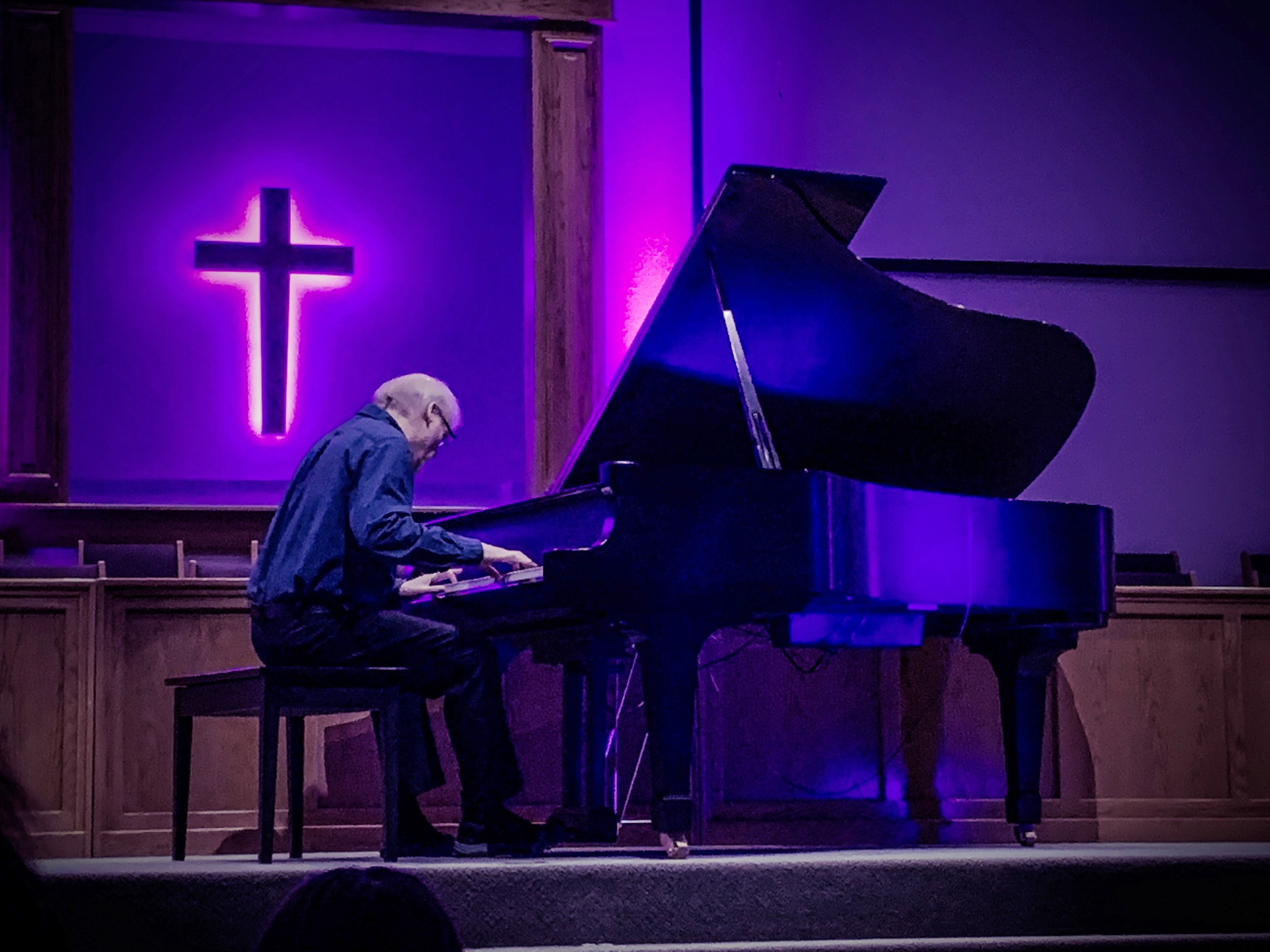 man playing a piano in a church