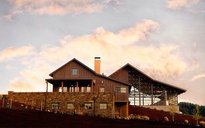 exterior of modern and rustic style building under sky with clouds