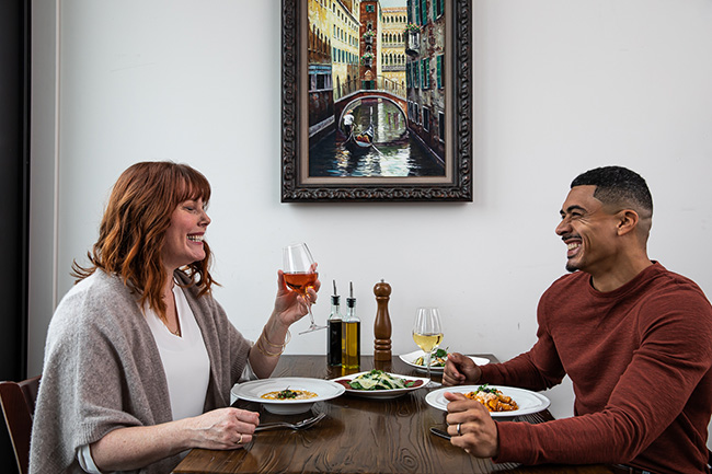 two people dining and laughing
