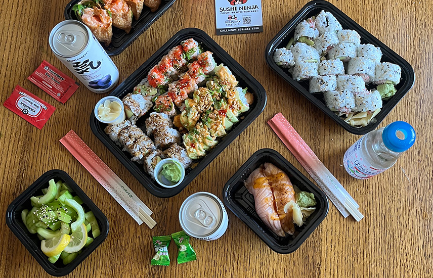 A variety of sushi, sashimi, and Japanese drinks