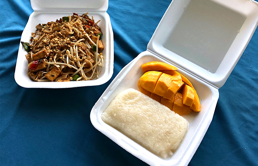 To-go containers full of pad thai and sweet mango sticky rice