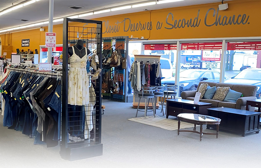 Clothes racks of jeans and dresses, used furniture, and a mural that says "Every closet deserves a second chance".