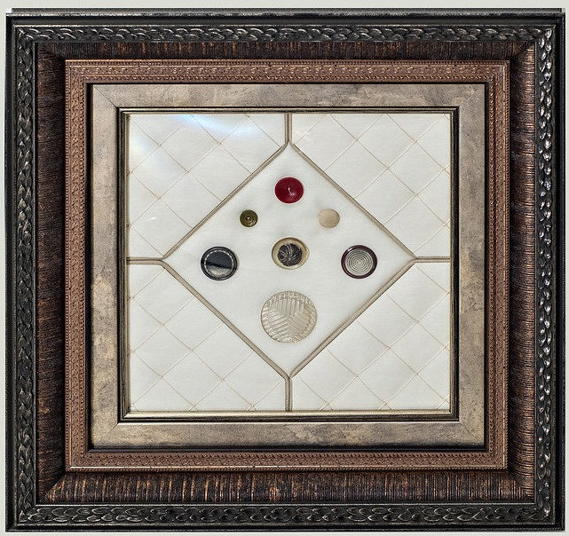 Tripled framed with buttons in the center