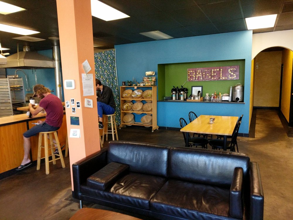 Photo of two people sitting at the bar with colorful walls
