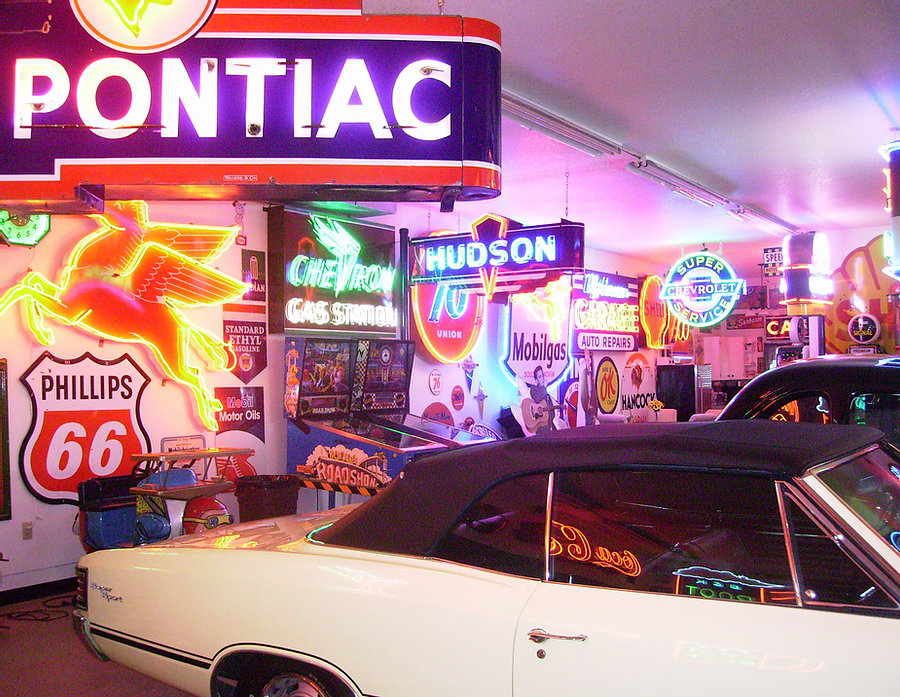 Cars surrounded by neon signs