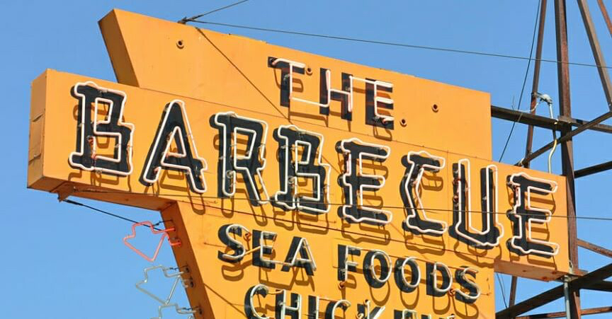 yellow stylized sign " the barbecue" sea foods chicken