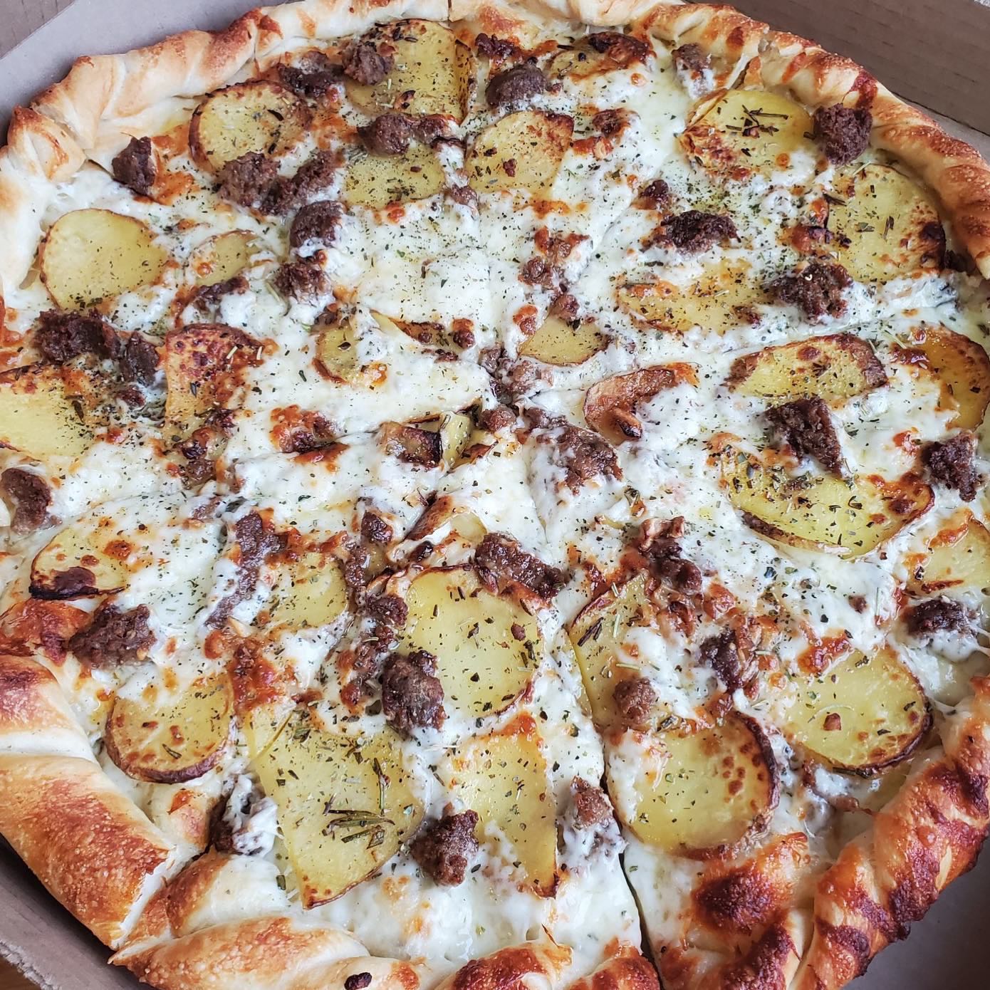 Cheesy pizza with potatoes and sausage