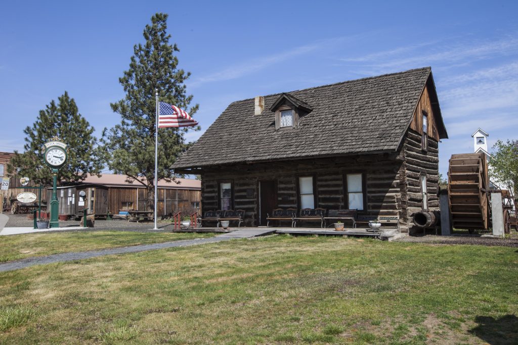 Log Cabin with mill, American flag