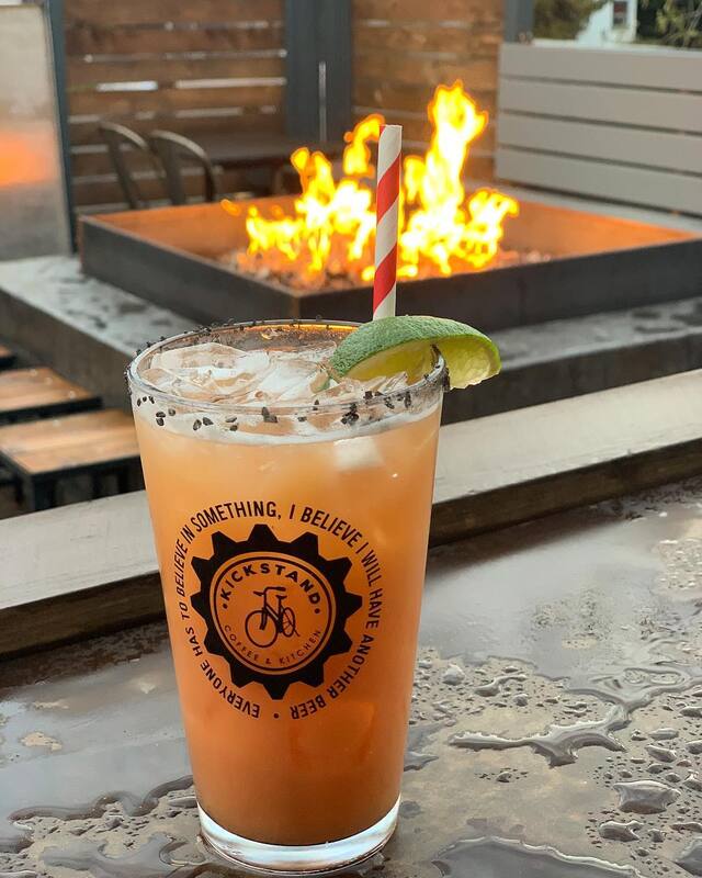 Fire in the background, foreground is an orange cocktail