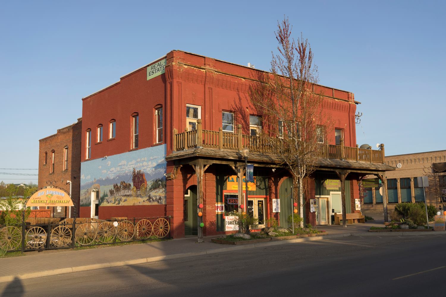 exterior of two story rustic western building with mural on side