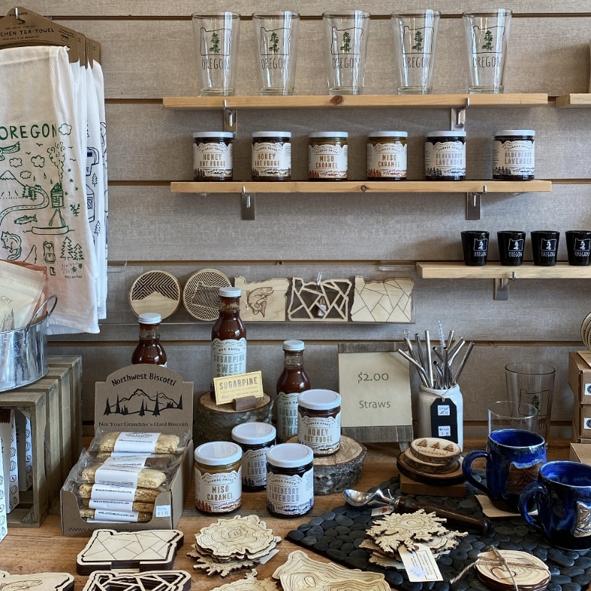 Locally made gifts celebrating the PNW sit on wooden shelves