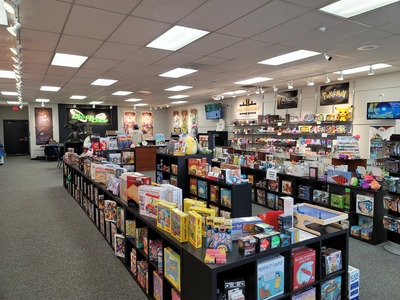 Bookcases filled with different games for sale inside Discs & Dice
