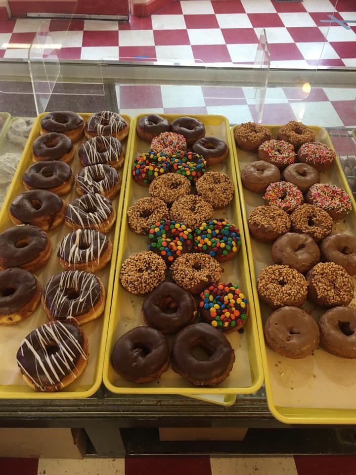 trays of donuts in display case