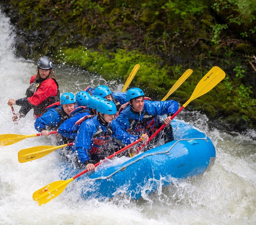 people in raft on white rapids