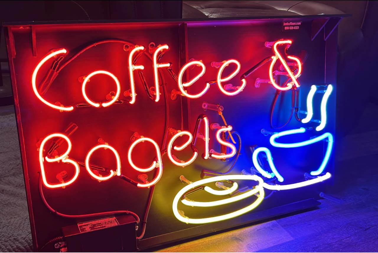 neon sign that says Coffee & Bagels with bagel and coffee cup
