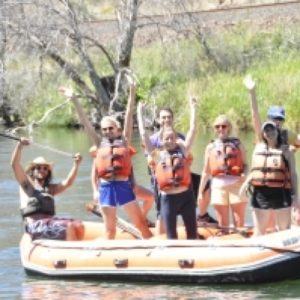 people on raft waving at camera