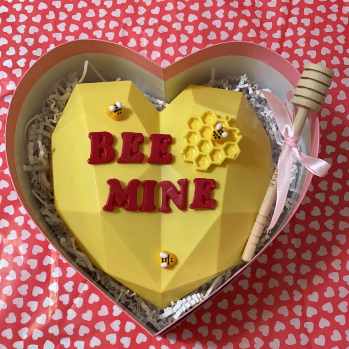 heart shaped cake with lettering BEE MINE and honey bee decorations