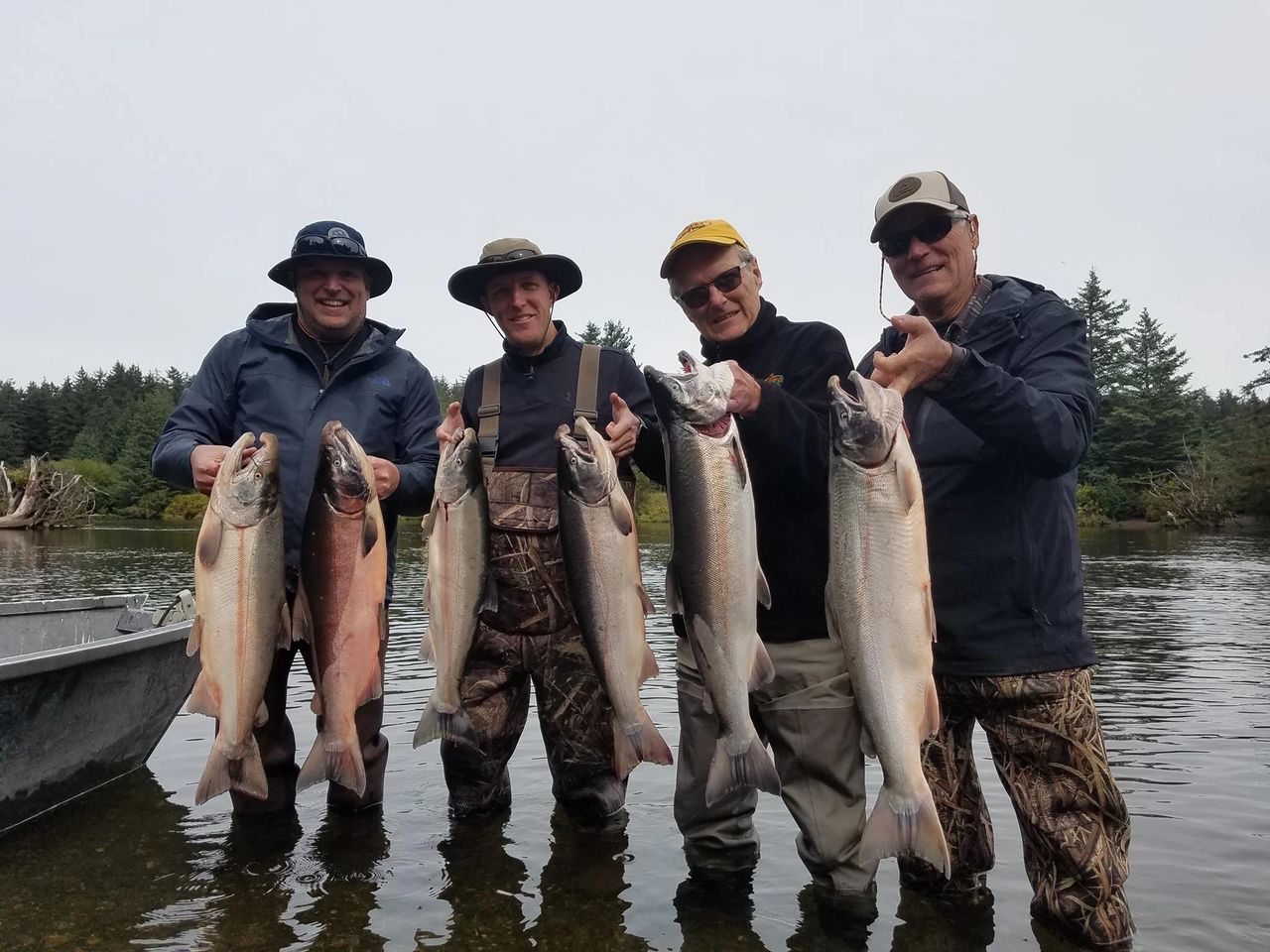 4 men with a fish in each hand