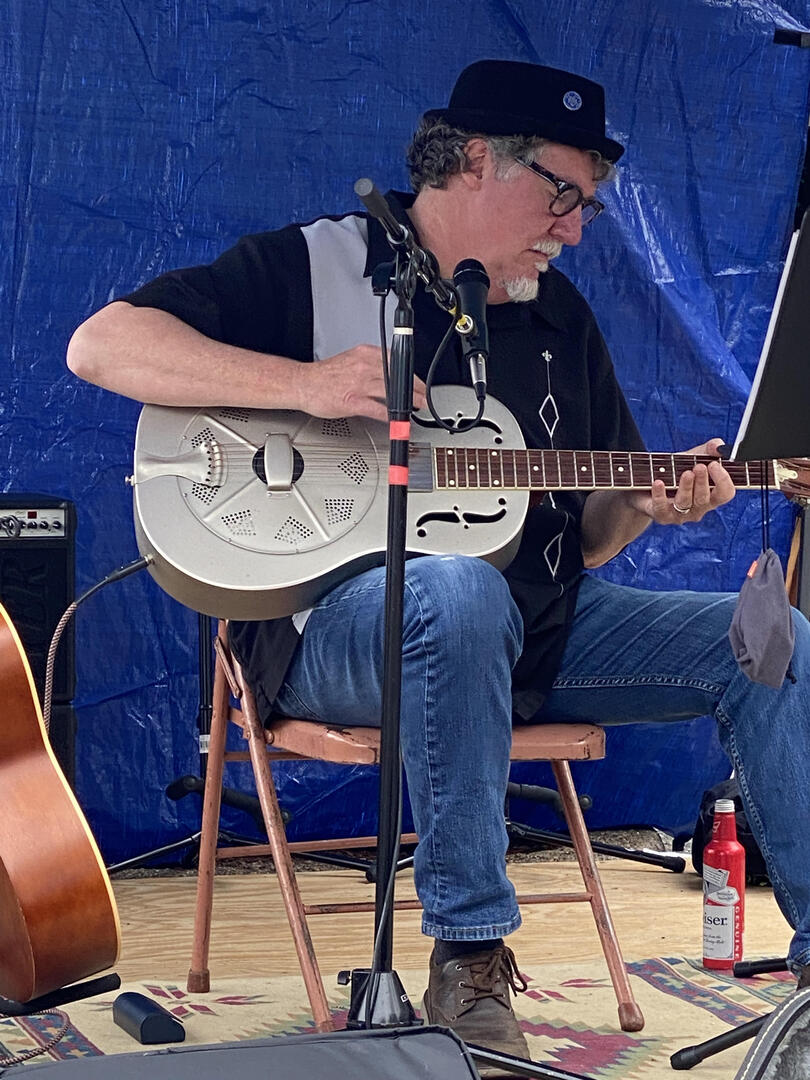 seated musician playing guitar