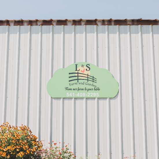 picture of L&S farm sign outside of warehouse