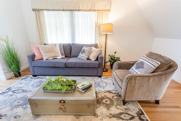 sitting area with love seat, chair and trunk as table