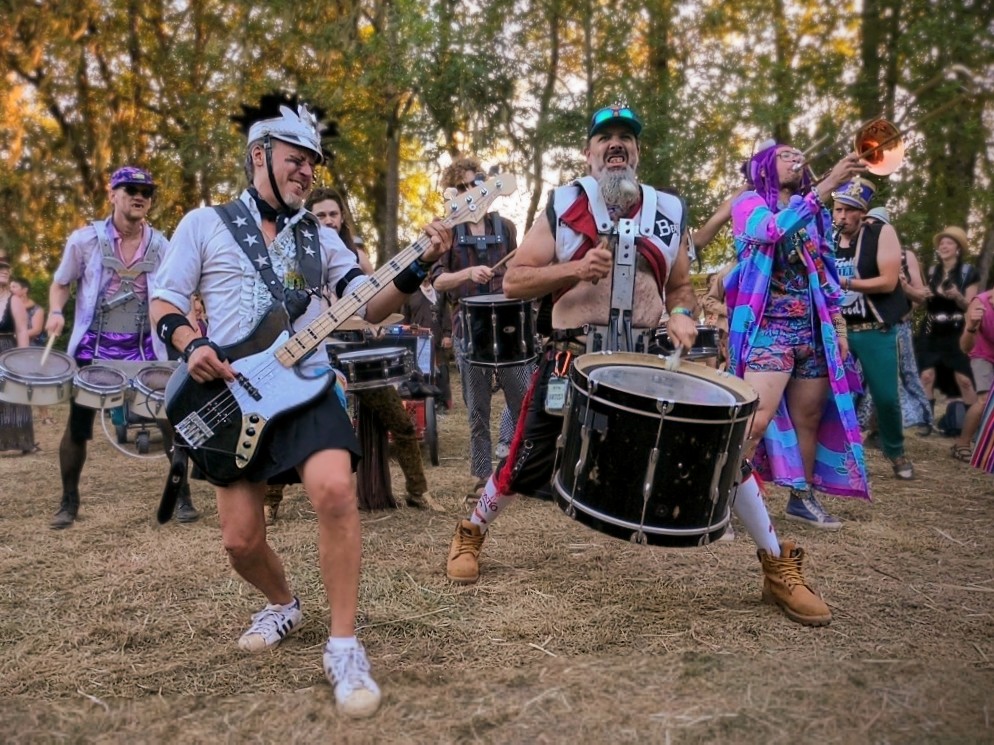 A group of people playing in a band at the Oregon Country Fair.