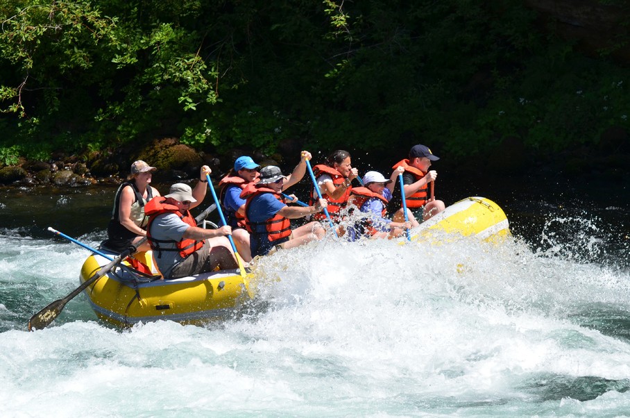 A group of people rafting down white water rapids